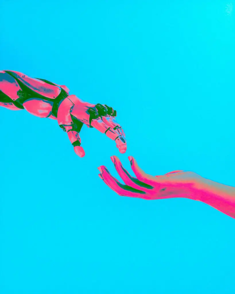 Robotic arm extending toward a human hand against a bright blue background